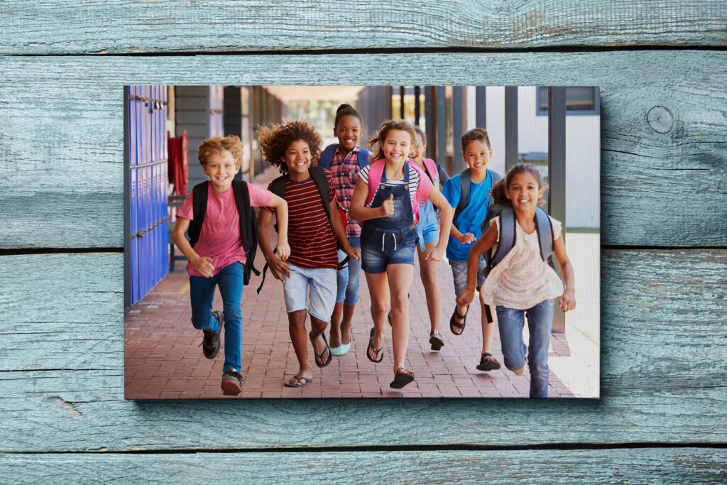 Happy kids running at school with backpacks