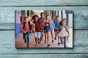 Happy kids running at school with backpacks